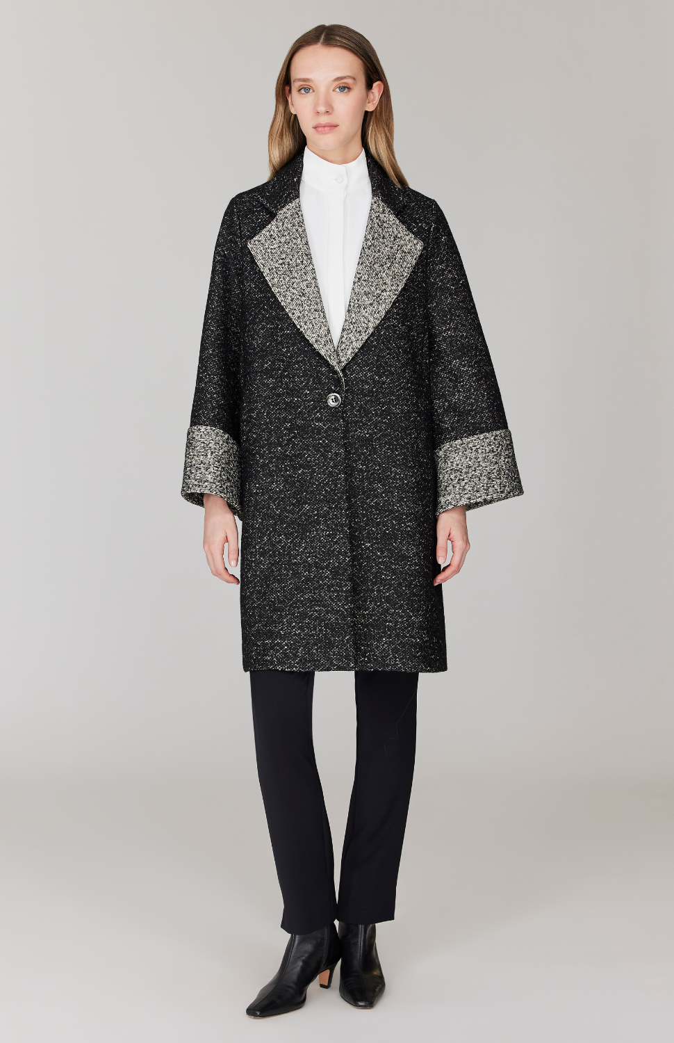 Morgan is 5' 11" and wearing Black and White in size XS.